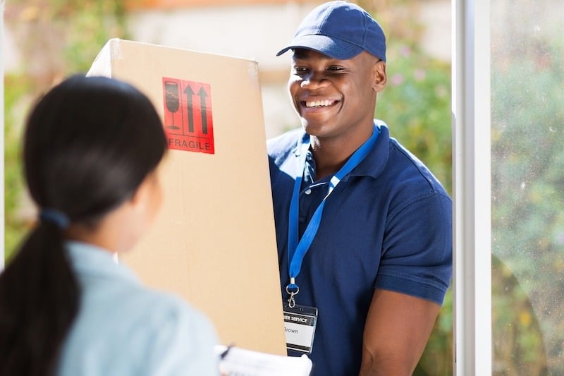 A Delivery Man Delivering a Fragile Package to a Homeowner