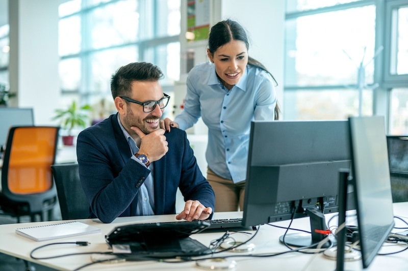 Two Office Personnel Looking at Computer Screen